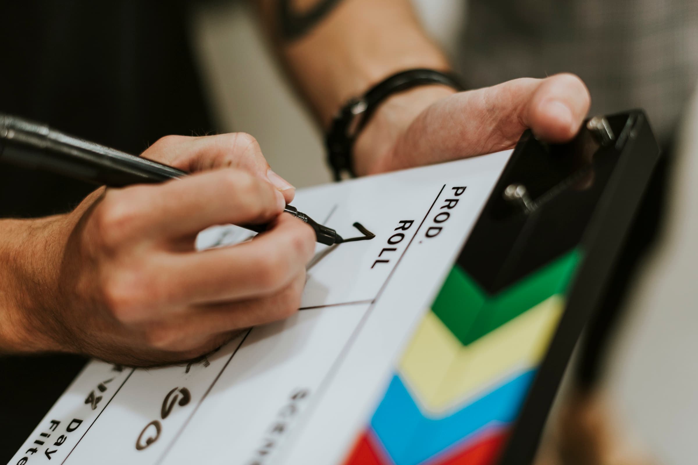 A crew member marking a film clapperboard